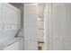 Laundry area with stacked washer/dryer and storage leading to the renovated bathroom at 6268 Palma Del Mar S Blvd # 101, St Petersburg, FL 33715
