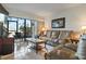 Living room featuring leather seating, tile floors, large windows, and access to the lanai at 6268 Palma Del Mar S Blvd # 101, St Petersburg, FL 33715