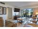 Living room with comfortable leather seating, a large TV, and sliding glass doors to the patio at 6268 Palma Del Mar S Blvd # 101, St Petersburg, FL 33715