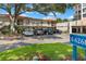 Parking area view outside the building with E-6268 sign and landscaping at 6268 Palma Del Mar S Blvd # 101, St Petersburg, FL 33715
