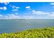 Beautiful water view with boat, buildings, and blue skies and puffy clouds at 6268 Palma Del Mar S Blvd # 101, St Petersburg, FL 33715