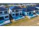 Aerial view of modern homes featuring private pools and fenced yards in a waterfront community at 6536 Simone Shores Cir, Apollo Beach, FL 33572