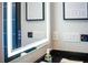 Modern bathroom features illuminated mirror with touch controls above the black countertop at 6536 Simone Shores Cir, Apollo Beach, FL 33572