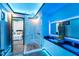 Modern bathroom with a glass shower, dual sinks, and ambient blue lighting at 6536 Simone Shores Cir, Apollo Beach, FL 33572