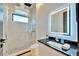Modern bathroom with a glass shower, rain shower head, and lighted mirror at 6536 Simone Shores Cir, Apollo Beach, FL 33572