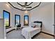 Charming bedroom featuring tray ceiling, recessed lights, and neighborhood views from three windows at 6536 Simone Shores Cir, Apollo Beach, FL 33572
