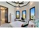 Sunlit bedroom with decorative tray ceiling and neighborhood views from three windows at 6536 Simone Shores Cir, Apollo Beach, FL 33572