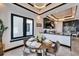 Modern dining area featuring sleek black cabinetry, a round table, and elegant pendant lighting at 6536 Simone Shores Cir, Apollo Beach, FL 33572