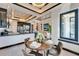 Bright dining area with elegant chandelier, open kitchen, and seamless flow to the living space at 6536 Simone Shores Cir, Apollo Beach, FL 33572