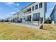 Exterior shot of a modern, luxury home showcasing the pool, backyard and balconies at 6536 Simone Shores Cir, Apollo Beach, FL 33572