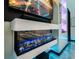 Close up on modern fireplace with blue flame, surrounded by custom shelving and ambient lighting at 6536 Simone Shores Cir, Apollo Beach, FL 33572