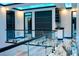 Contemporary hallway with marble floors, glass railings and modern black doors, showcasing stylish design at 6536 Simone Shores Cir, Apollo Beach, FL 33572
