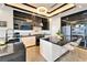 Modern kitchen with black cabinets, granite countertops, and stainless steel appliances at 6536 Simone Shores Cir, Apollo Beach, FL 33572