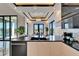 Bright kitchen with black granite counters, an island, and elegant pendant lighting above the dining area at 6536 Simone Shores Cir, Apollo Beach, FL 33572