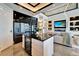 Modern kitchen and living room featuring a black granite island, sleek cabinetry, and open floor plan at 6536 Simone Shores Cir, Apollo Beach, FL 33572