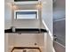 Modern laundry room featuring sleek black countertops and a window for natural light at 6536 Simone Shores Cir, Apollo Beach, FL 33572