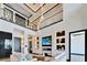 Spacious living room with soaring ceilings, modern fireplace, built-in shelving, and elegant decor at 6536 Simone Shores Cir, Apollo Beach, FL 33572