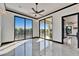 Bright space with light-reflecting floors, a ceiling fan, and sliding glass doors to the pool at 6536 Simone Shores Cir, Apollo Beach, FL 33572