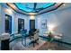 Modern home office features unique lighting, white desk chair, and sleek desk at 6536 Simone Shores Cir, Apollo Beach, FL 33572