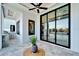 Comfortable outdoor patio with BBQ, ceiling fan, and sliding doors with views of the garden and pool at 6536 Simone Shores Cir, Apollo Beach, FL 33572