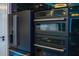Close-up of modern black stainless steel appliances including a large fridge and oven array at 6536 Simone Shores Cir, Apollo Beach, FL 33572
