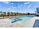 Backyard view featuring a pool and spa with canal view beyond the black fence at 6536 Simone Shores Cir, Apollo Beach, FL 33572
