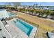 Aerial view of a sparkling pool with a spa, surrounded by a paved patio and black fence at 6536 Simone Shores Cir, Apollo Beach, FL 33572