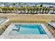 Aerial view of a private pool and spa surrounded by a black fence and landscaping at 6536 Simone Shores Cir, Apollo Beach, FL 33572