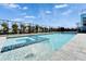 Relaxing backyard pool and spa combo with blue tile accents, surrounded by lush landscaping at 6536 Simone Shores Cir, Apollo Beach, FL 33572