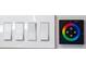 Close-up of light switches with a color wheel button on the wall at 6536 Simone Shores Cir, Apollo Beach, FL 33572