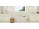 Bright bathroom featuring a standalone soaking tub, dual vanities, and window at 6841 E 115Th St, Palmetto, FL 34221