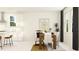 Modern dining room with a wooden table, white chairs, and stylish decor at 6841 E 115Th St, Palmetto, FL 34221