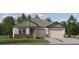 Charming single-story home features a two-car garage, manicured lawn, and stylish stone accents at 6841 E 115Th St, Palmetto, FL 34221