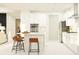 Bright kitchen features white cabinets, stainless steel appliances, and a breakfast bar at 6841 E 115Th St, Palmetto, FL 34221
