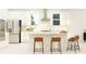Modern kitchen with a large island, stainless steel appliances, and sleek white cabinetry at 6841 E 115Th St, Palmetto, FL 34221