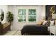 Serene main bedroom with a large window, dresser, and stylish decor at 6841 E 115Th St, Palmetto, FL 34221