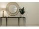 Elegant entryway featuring a sleek console table, round mirror, and stylish plant for decor at 7529 E 116Th St, Palmetto, FL 34221
