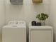Functional laundry room with white washer and dryer, overhead shelving, and space-saving design at 7529 E 116Th St, Palmetto, FL 34221
