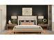 Serene main bedroom with a luxurious bed, accent wall, and elegant nightstands at 7529 E 116Th St, Palmetto, FL 34221
