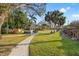 Expansive backyard featuring mature trees, a hammock, and gravel paths, perfect for outdoor living and relaxation at 10098 Oaks Ln, Seminole, FL 33772