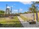 Spacious backyard with lush green grass, a dining area, and a gravel pathway, ideal for outdoor enjoyment at 10098 Oaks Ln, Seminole, FL 33772