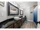 Modern bathroom with dual vanity, dark cabinets, vessel sinks, and elegant fixtures at 10098 Oaks Ln, Seminole, FL 33772