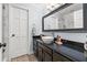 Stylish bathroom with dark cabinets, vessel sink, granite countertop, and modern finishes at 10098 Oaks Ln, Seminole, FL 33772