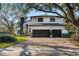 Charming two-story home with a three-car garage and landscaped front yard at 10098 Oaks Ln, Seminole, FL 33772