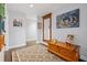 Hallway featuring wood floors, neutral paint, decorative decor, and a large mirror at 10098 Oaks Ln, Seminole, FL 33772