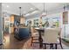 Kitchen featuring wood cabinets, an island, and view to the breakfast nook and outside patio at 10098 Oaks Ln, Seminole, FL 33772