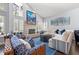 Bright living room featuring a large sectional sofa, stone fireplace, and hardwood floors at 10098 Oaks Ln, Seminole, FL 33772