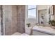 Bright bathroom featuring tiled shower and white vanity and mirror at 10809 Patoka Ter, Parrish, FL 34219