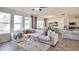 Cozy living room featuring neutral decor, a plush sofa, and three bright windows at 10809 Patoka Ter, Parrish, FL 34219