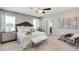 Calming main bedroom with plush bedding, neutral colors, and a doorway to the en-suite bathroom at 10809 Patoka Ter, Parrish, FL 34219